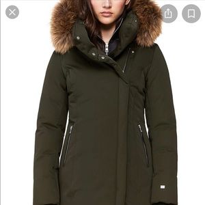 A slim fit mid-length coat with a puffy hood, rib knit collar, and down fabric.